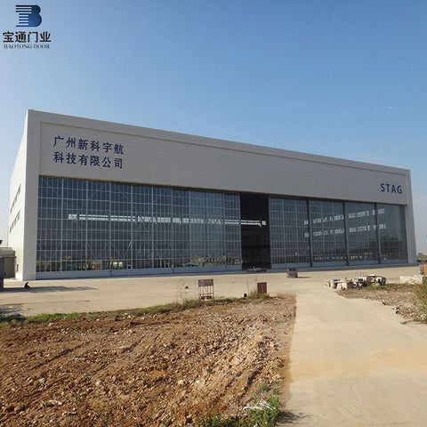 Low price industrial bi-parting sliding hangar folding door system on China WDMA